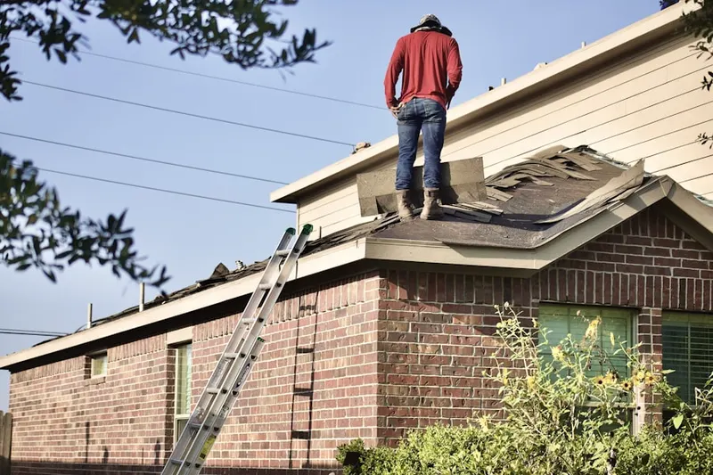 Professional roofer working on a residential roof in Tylerville